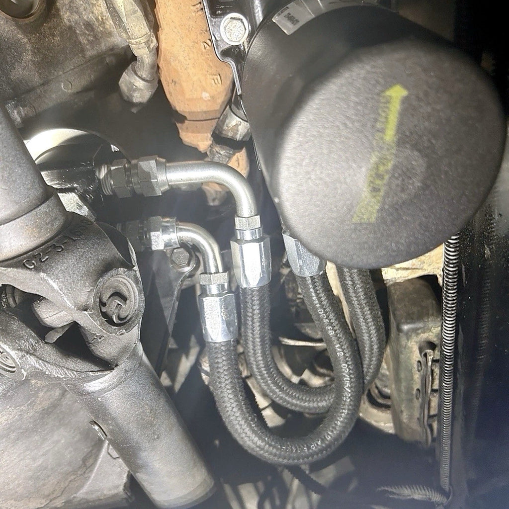 SABAR H1 bypass kit block adapter and braided oil line routing installed on 6.5L Turbo Diesel