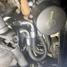 Load image into Gallery viewer, SABAR H1 bypass kit block adapter and braided oil line routing installed on 6.5L Turbo Diesel