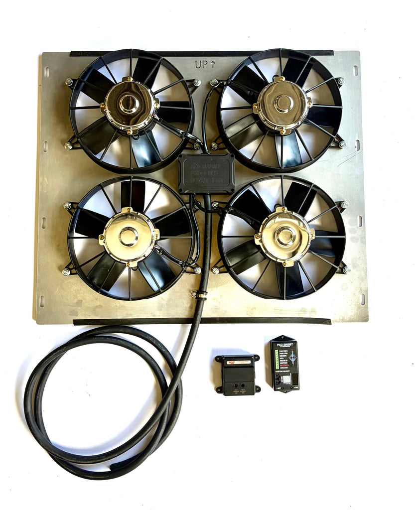 An automotive radiator cooling fan assembly with an aluminum metal frame, four black fans, a black wiring harness, and two small black electronic control modules on a white background.