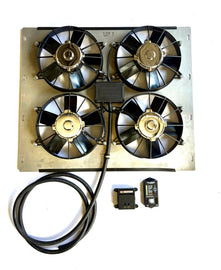An automotive radiator cooling fan assembly with an aluminum metal frame, four black fans, a black wiring harness, and two small black electronic control modules on a white background.