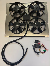 A cooling fan assembly with an aluminum metal shroud, four black fans, a black wiring harness, a black wiring housing, and two small black electronic modules on a white background.